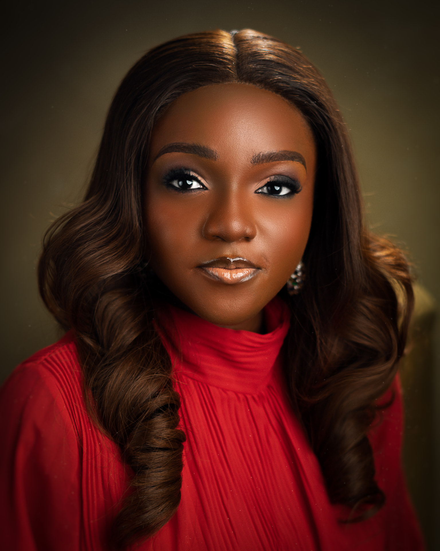 Portrait of Ijidolapo Success Ijiwoye in a red high-neck dress.
